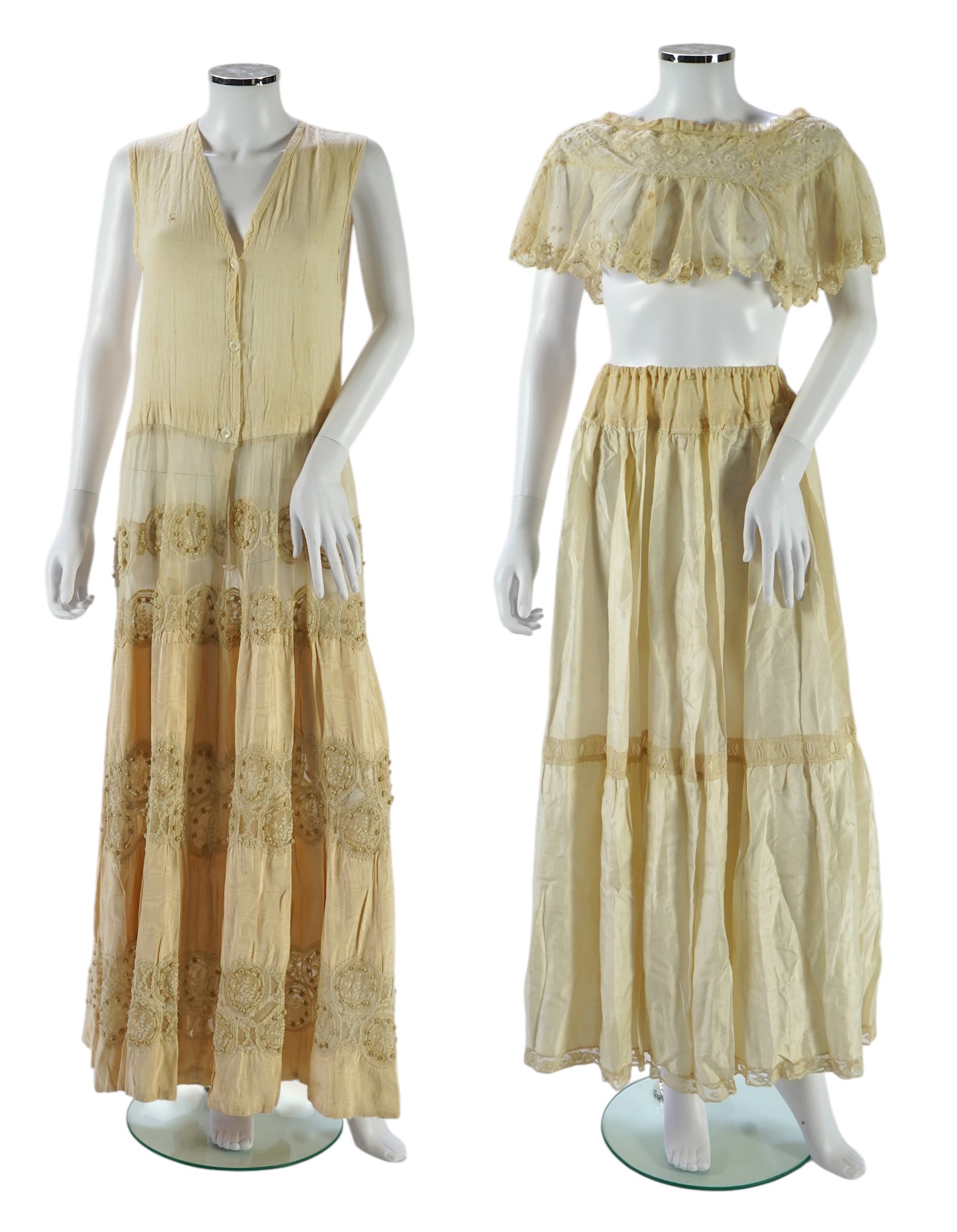 A suitcase containing a cream silk lace skirt to a dress, an Edwardian silk petticoat and various collars, possibly for theatrical use, silk petticoat 96 cm long. Condition - fair